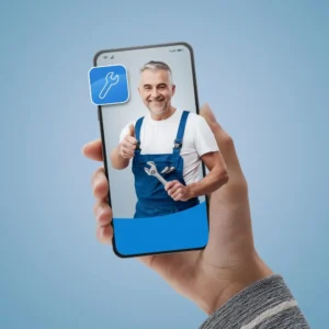 A person is holding a cell phone with a picture of a man holding a wrench on the screen.