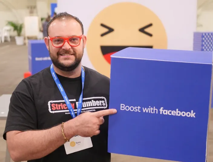 A man holding a box that says boost with facebook